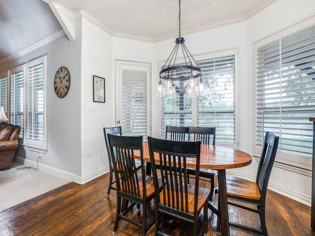 dining space with a notable chandelier, baseboards, ornamental molding, and dark wood-type flooring