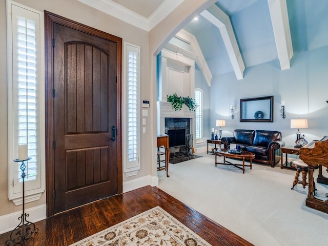 foyer featuring ornamental molding, plenty of natural light, wood finished floors, and baseboards