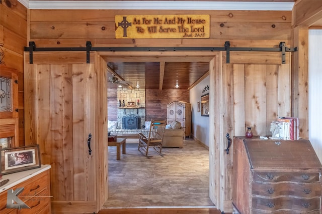 living area featuring wood walls and a barn door