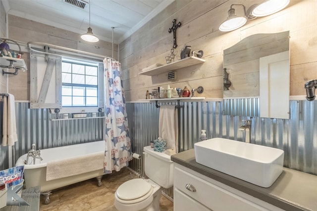 full bathroom featuring toilet, wood walls, visible vents, and vanity