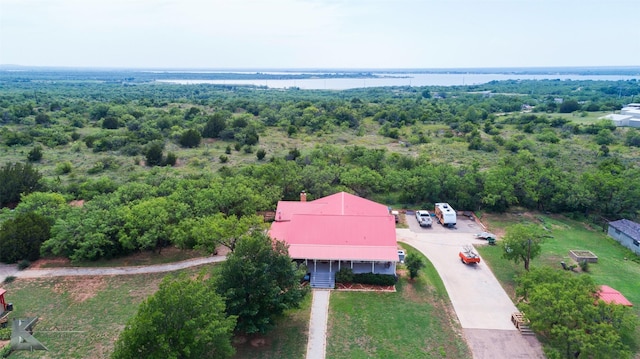 aerial view with a water view and a forest view