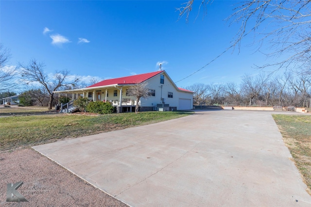 view of front of house with a porch, concrete driveway, and a front lawn