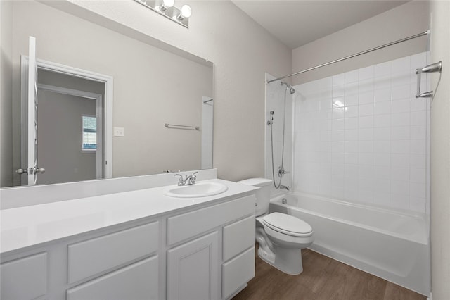 full bath featuring washtub / shower combination, vanity, toilet, and wood finished floors