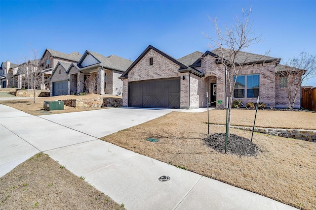 view of front of home with a garage, driveway, and brick siding