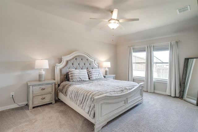 bedroom with a ceiling fan, light colored carpet, visible vents, and baseboards