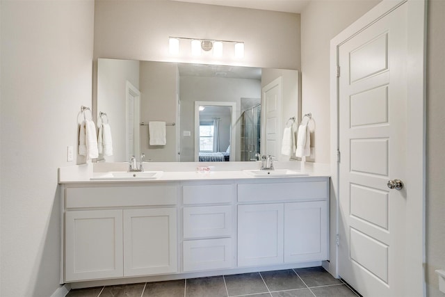 bathroom with tile patterned floors, a shower with shower door, a sink, and double vanity