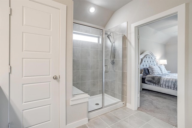 ensuite bathroom featuring recessed lighting, vaulted ceiling, connected bathroom, a shower stall, and tile patterned floors