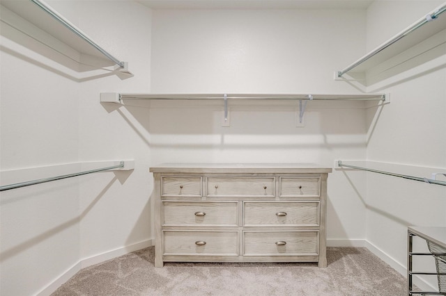 walk in closet featuring light carpet