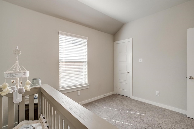 unfurnished bedroom with vaulted ceiling, carpet, and baseboards