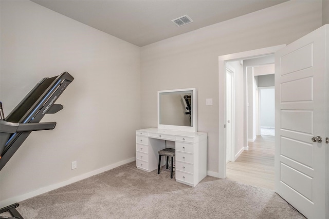 home office featuring light carpet, visible vents, and baseboards