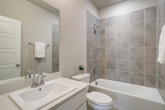 bathroom featuring washtub / shower combination, vanity, and toilet