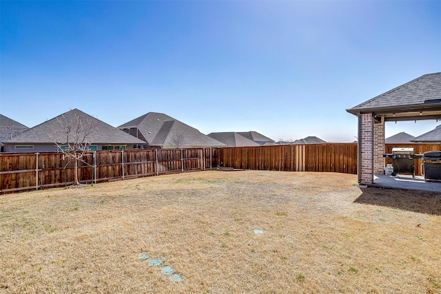 view of yard with a fenced backyard and a patio