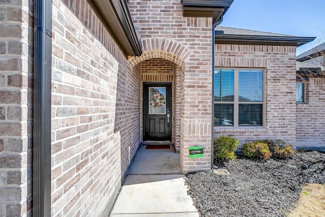 property entrance with brick siding