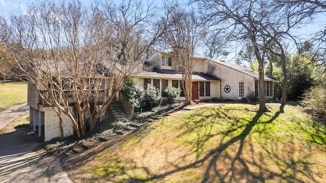 view of front of property with stairs, a front lawn, and stucco siding