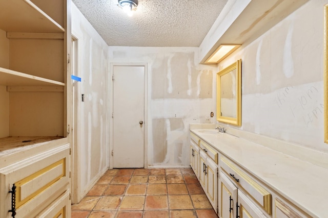 bathroom with a textured ceiling and vanity