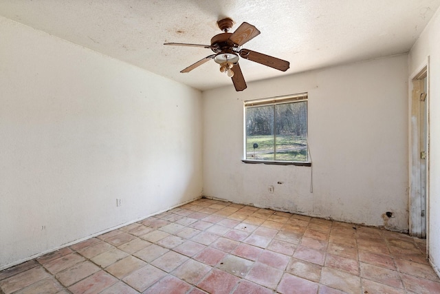 spare room with a ceiling fan and a textured ceiling