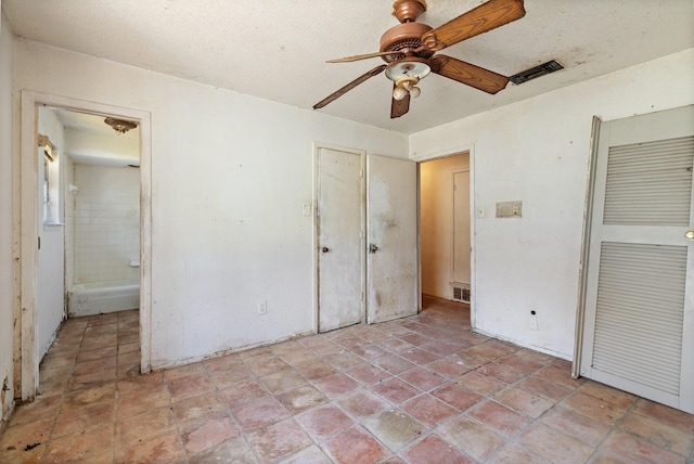 unfurnished bedroom with a closet, visible vents, and a ceiling fan