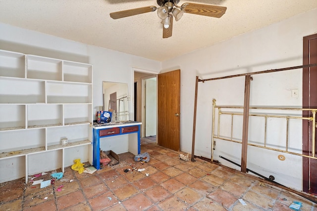 interior space featuring a textured ceiling and ceiling fan