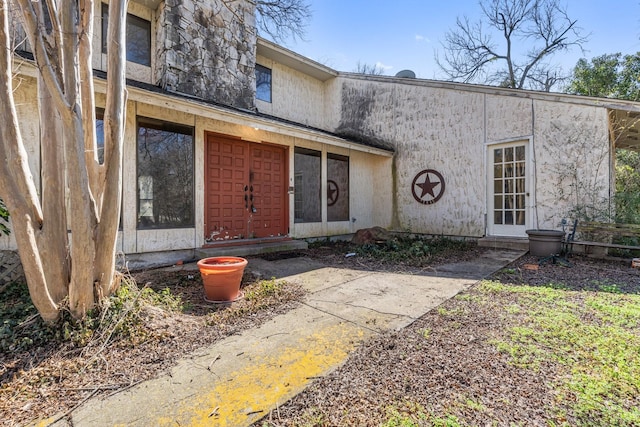 doorway to property with stucco siding