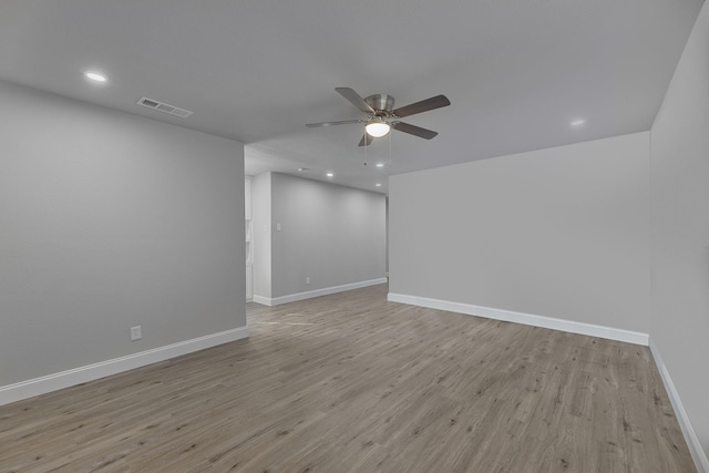 empty room with recessed lighting, visible vents, light wood-style floors, a ceiling fan, and baseboards