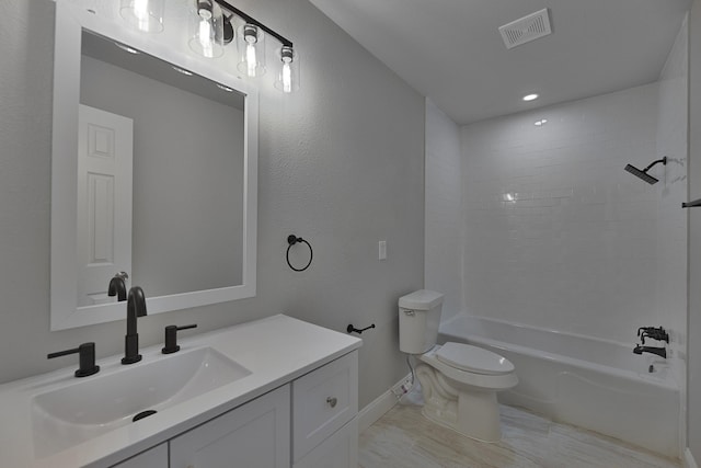 bathroom with shower / washtub combination, visible vents, vanity, and toilet