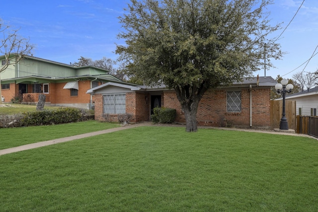 ranch-style home featuring a front lawn, fence, and brick siding