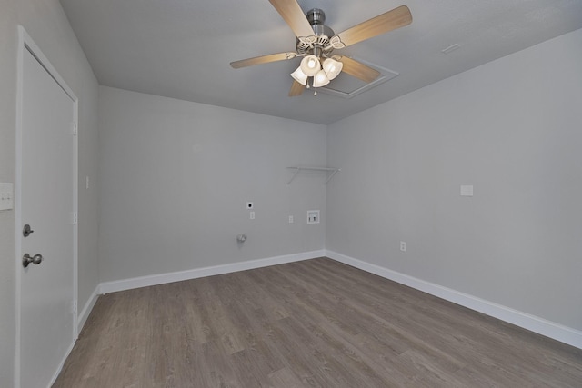 spare room with dark wood-type flooring, attic access, baseboards, and a ceiling fan