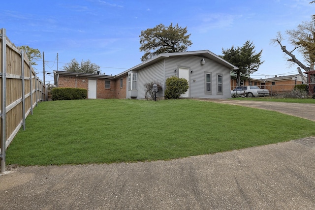 view of side of property featuring a yard and fence