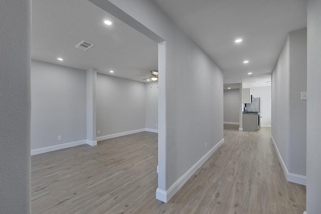 hall featuring visible vents, recessed lighting, light wood-style flooring, and baseboards