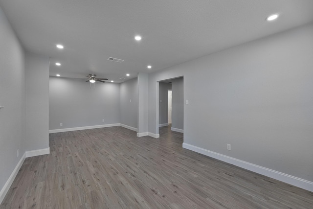 unfurnished room with visible vents, baseboards, a ceiling fan, wood finished floors, and recessed lighting