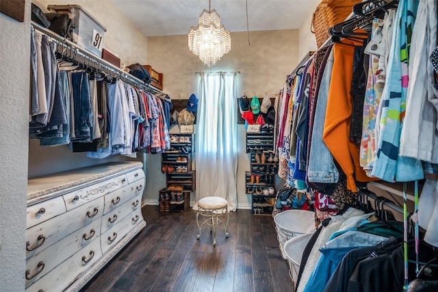 walk in closet with a chandelier and hardwood / wood-style floors