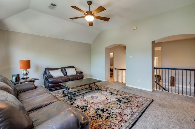 living room featuring arched walkways, vaulted ceiling, carpet flooring, and visible vents