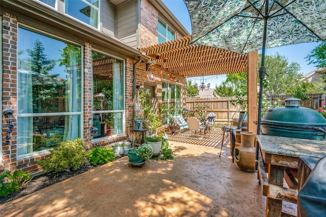 view of patio / terrace featuring fence, a pergola, and area for grilling