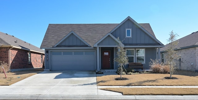 view of front facade with board and batten siding, concrete driveway, roof with shingles, and an attached garage