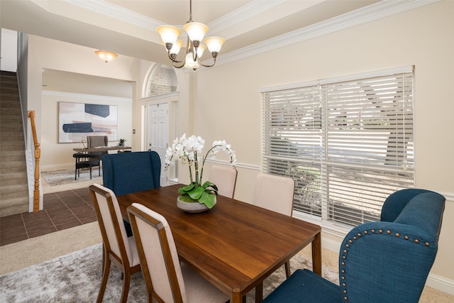 dining room featuring a notable chandelier, ornamental molding, stairway, tile patterned floors, and a raised ceiling