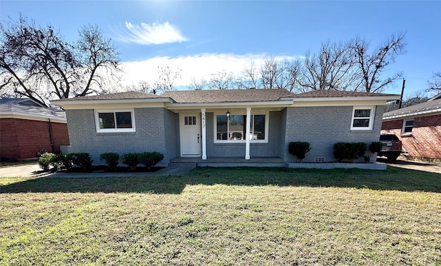 ranch-style house featuring a front yard, covered porch, and brick siding