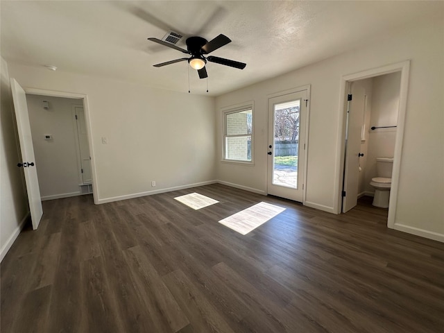 unfurnished bedroom with access to outside, dark wood-style flooring, and baseboards