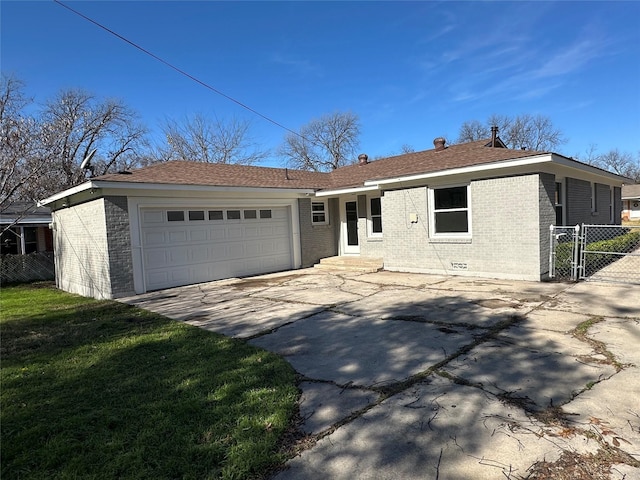 ranch-style house with an attached garage, brick siding, fence, concrete driveway, and a front lawn