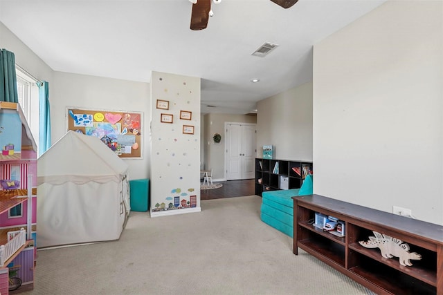 playroom featuring carpet floors, visible vents, and baseboards