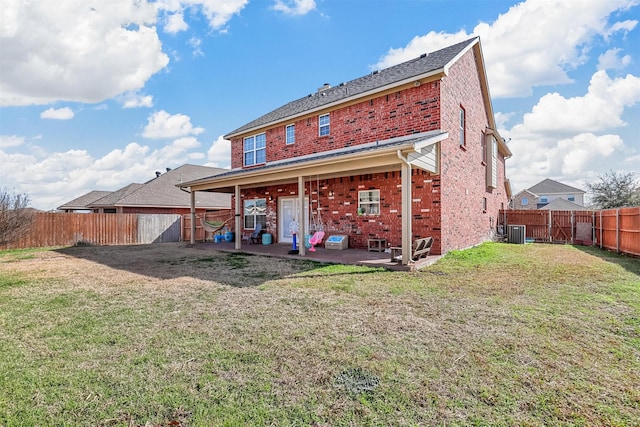 back of property featuring a fenced backyard, a lawn, a patio, and brick siding