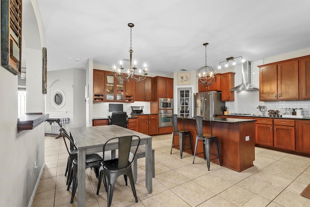 kitchen with stainless steel appliances, a center island, wall chimney exhaust hood, tasteful backsplash, and dark countertops