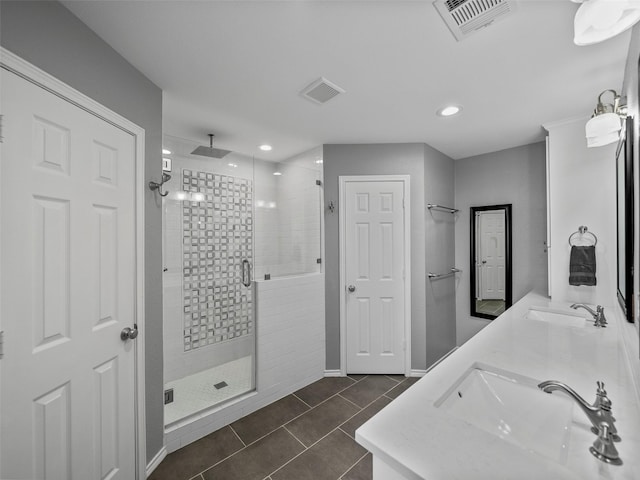 full bathroom featuring visible vents, a sink, and a shower stall