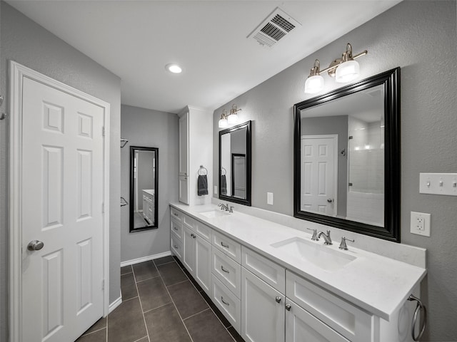 bathroom with tile patterned flooring, visible vents, a sink, and double vanity