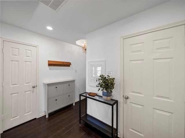 interior space with baseboards, visible vents, dark wood-style floors, an inviting chandelier, and recessed lighting