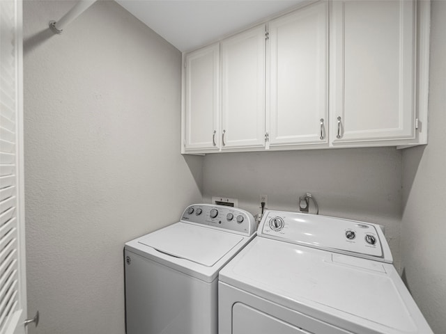 laundry room with cabinet space and washer and dryer