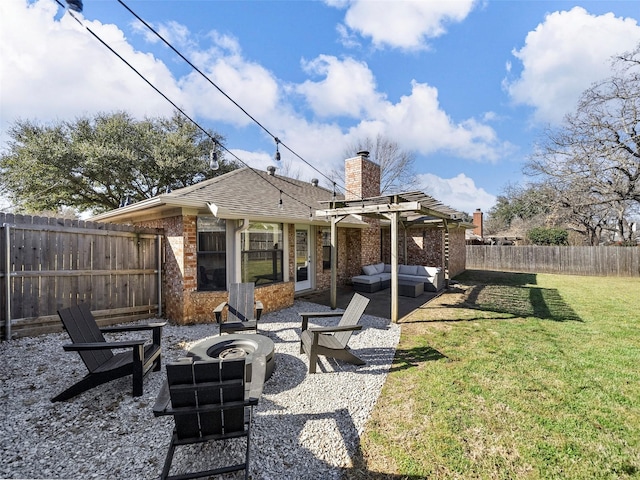 back of property featuring a fenced backyard, brick siding, a lawn, a chimney, and an outdoor living space with a fire pit