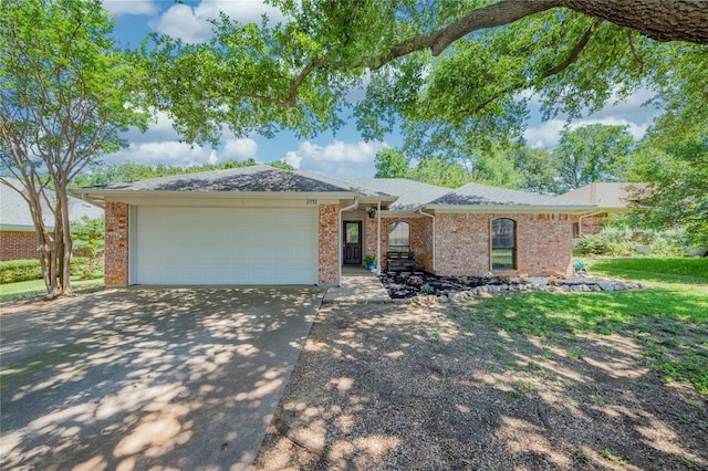 ranch-style house with driveway, brick siding, an attached garage, and a shingled roof