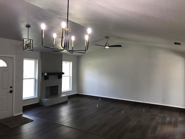 interior space featuring vaulted ceiling, dark wood-style flooring, a fireplace, and baseboards