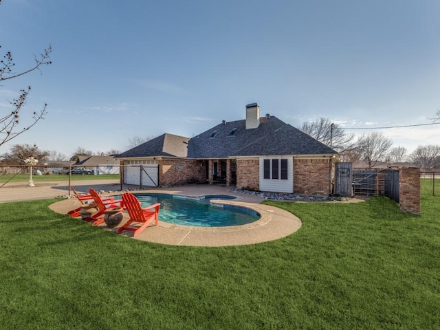 view of pool featuring a patio, a lawn, fence, and a gate