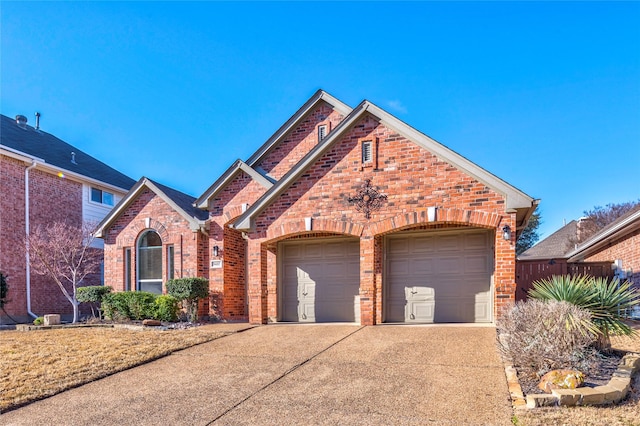 view of front facade with a garage, brick siding, and driveway